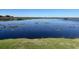 Peaceful lake view with dock and lush vegetation at 1501 Sunset Pointe Pl, Kissimmee, FL 34744