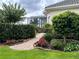 Brick pathway through a beautifully landscaped garden at 1501 Sunset Pointe Pl, Kissimmee, FL 34744