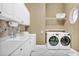Bright laundry room with washer, dryer, and ample storage at 1501 Sunset Pointe Pl, Kissimmee, FL 34744