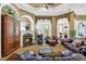 Comfortable living room with fireplace and access to outdoor patio at 1501 Sunset Pointe Pl, Kissimmee, FL 34744
