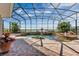 Inviting screened pool with a fountain and lush landscaping at 1501 Sunset Pointe Pl, Kissimmee, FL 34744