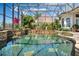 Stunning screened pool and spa with stonework and fountain at 1501 Sunset Pointe Pl, Kissimmee, FL 34744