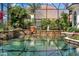 Stunning pool with a central fountain and lush greenery at 1501 Sunset Pointe Pl, Kissimmee, FL 34744