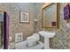 Charming powder room with floral wallpaper and pedestal sink at 1501 Sunset Pointe Pl, Kissimmee, FL 34744