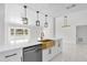 Renovated kitchen featuring a copper farm sink and modern lighting at 1538 N Normandy Blvd, Deltona, FL 32725