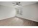 Spacious bedroom featuring wood-look floors and a large window at 1621 Ne 2Nd St # 203, Ocala, FL 34470