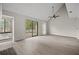 Living area with sliding doors to deck and laminate floors at 1621 Ne 2Nd St # 203, Ocala, FL 34470