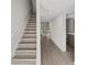 Stylish staircase and hallway with laminate flooring at 1621 Ne 2Nd St # 203, Ocala, FL 34470