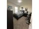 Well-lit bedroom with a full-size bed and workspace at 2459 Taloncrest Ct, Eagle Lake, FL 33839