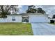 One-story house with attached garage, driveway, and landscaped lawn at 551 Albatross Dr, Poinciana, FL 34759