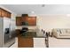 Kitchen with dark brown cabinets, granite countertops, and stainless steel appliances at 9475 Randal Park Blvd, Orlando, FL 32832