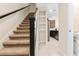 Carpeted staircase with dark brown railing and built in shelving at 9475 Randal Park Blvd, Orlando, FL 32832