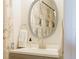 Small bathroom with vanity, oval mirror, and neutral color scheme at 3112 Armstrong Spring Dr, Kissimmee, FL 34744