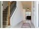 Bright entryway with tiled floor, staircase, and view into living room at 3112 Armstrong Spring Dr, Kissimmee, FL 34744