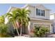 Two-story house with light beige siding, a two-car garage, and landscaping at 3112 Armstrong Spring Dr, Kissimmee, FL 34744