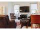 Relaxing living room featuring comfortable seating and a large TV at 3112 Armstrong Spring Dr, Kissimmee, FL 34744