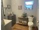 Updated bathroom with a modern vanity and decorative accents at 4040 Ne 95Th Rd, Wildwood, FL 34785