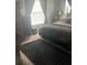 Bright bedroom with a queen-size bed and wood floors at 4040 Ne 95Th Rd, Wildwood, FL 34785