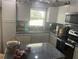 Well-equipped kitchen featuring granite countertops and ample cabinet space at 4040 Ne 95Th Rd, Wildwood, FL 34785