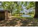 Small storage shed near tranquil pond and lush trees at 6225, 6229 Deen Still Rd, Lakeland, FL 33809