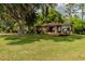Charming ranch home with a large yard, mature trees, and a deck at 6225, 6229 Deen Still Rd, Lakeland, FL 33809