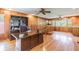 Spacious home office features wood paneled walls, built-in shelving, and hardwood floors at 6225, 6229 Deen Still Rd, Lakeland, FL 33809