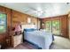 Cozy bedroom with wood-paneled walls and access to the outdoors at 6225, 6229 Deen Still Rd, Lakeland, FL 33809