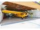 Spacious hangar with a yellow airplane and ample storage at 6225, 6229 Deen Still Rd, Lakeland, FL 33809