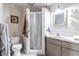 Clean bathroom with a shower, toilet, and vanity with storage at 6225, 6229 Deen Still Rd, Lakeland, FL 33809