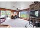 Comfortable living room with a fireplace, large windows, and views of the outdoors at 6225, 6229 Deen Still Rd, Lakeland, FL 33809