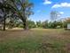 Spacious backyard with lush grass and large oak tree at 6106 Pine Nw Ave, Lakeland, FL 33810