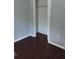 Empty bedroom with dark laminate wood flooring and a closet at 139 Oak View Pl, Sanford, FL 32773