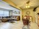 Open living room with sectional sofa and dining area at 9460 Sw 84Th Ter # F, Ocala, FL 34481