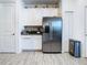 Kitchen with stainless steel refrigerator and white cabinets at 590 Tanaro Ln, Haines City, FL 33844