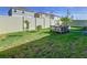Fenced backyard with grassy area and raised garden beds at 590 Tanaro Ln, Haines City, FL 33844