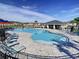 Community pool with plenty of lounge chairs at 590 Tanaro Ln, Haines City, FL 33844