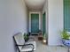 Inviting front porch with seating area and green door at 590 Tanaro Ln, Haines City, FL 33844