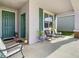 Front porch with rocking chairs and potted plants, welcoming entrance at 590 Tanaro Ln, Haines City, FL 33844