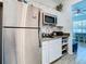 Small kitchen with stainless steel appliances and white cabinets at 590 Tanaro Ln, Haines City, FL 33844