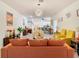 Living area with orange and yellow sofas and a marble top table at 590 Tanaro Ln, Haines City, FL 33844
