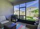 Relaxing screened patio with seating and grill at 590 Tanaro Ln, Haines City, FL 33844
