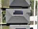 Aerial view of a house with solar panels on the roof at 590 Tanaro Ln, Haines City, FL 33844