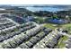 Aerial view of neighborhood with lake and homes at 590 Tanaro Ln, Haines City, FL 33844
