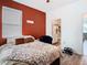 Bedroom with burnt orange accent wall and en-suite bathroom at 590 Tanaro Ln, Haines City, FL 33844