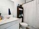 Bathroom with vanity, toilet, and shower with curtain at 590 Tanaro Ln, Haines City, FL 33844