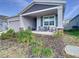 Two-story house with a covered porch and landscaping at 590 Tanaro Ln, Haines City, FL 33844