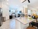 Modern kitchen with island, white cabinets, and stainless steel appliances at 590 Tanaro Ln, Haines City, FL 33844