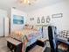 Bedroom with floral bedding, large artwork, and comfortable seating at 590 Tanaro Ln, Haines City, FL 33844