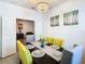 Elegant dining room with a dark wood table and yellow chairs at 590 Tanaro Ln, Haines City, FL 33844