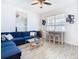 Open living space featuring a blue sectional sofa and a breakfast bar at 590 Tanaro Ln, Haines City, FL 33844